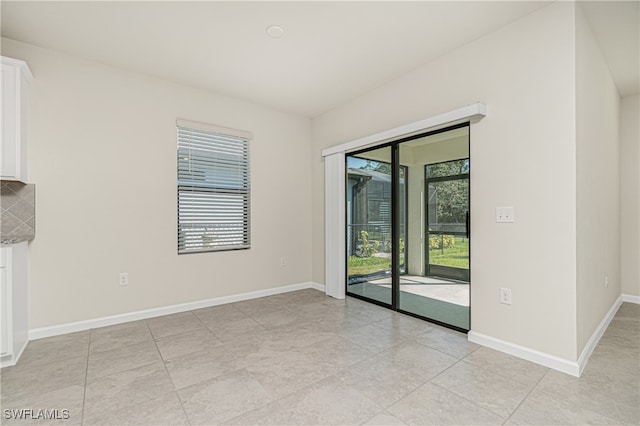 spare room with light tile patterned floors