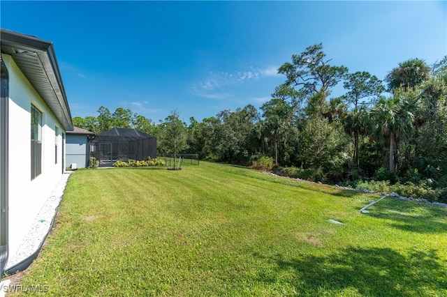 view of yard featuring glass enclosure