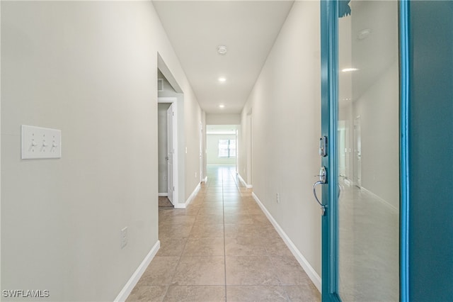 corridor featuring light tile patterned floors