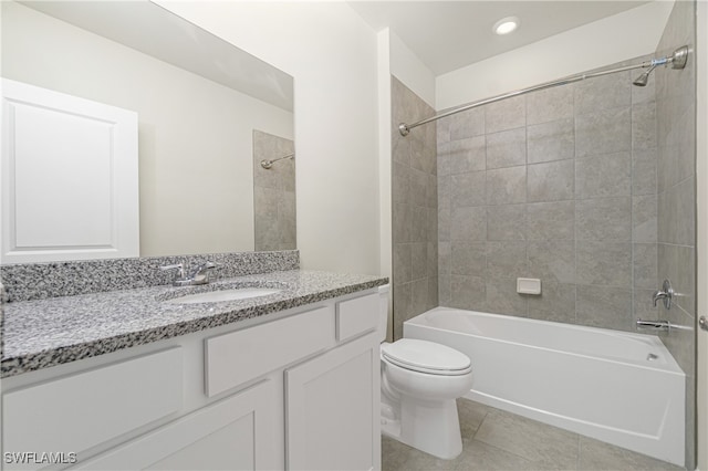 full bathroom featuring toilet, tiled shower / bath combo, vanity, and tile patterned floors