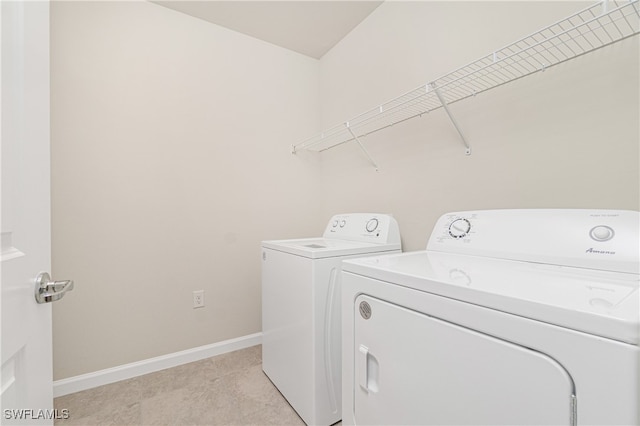 clothes washing area featuring separate washer and dryer