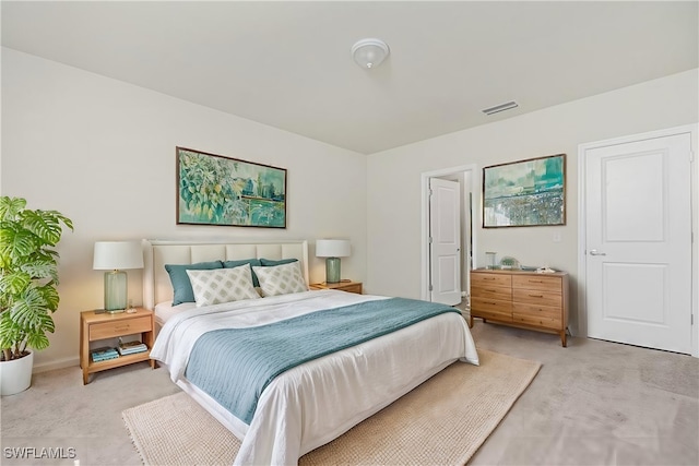 bedroom featuring light carpet