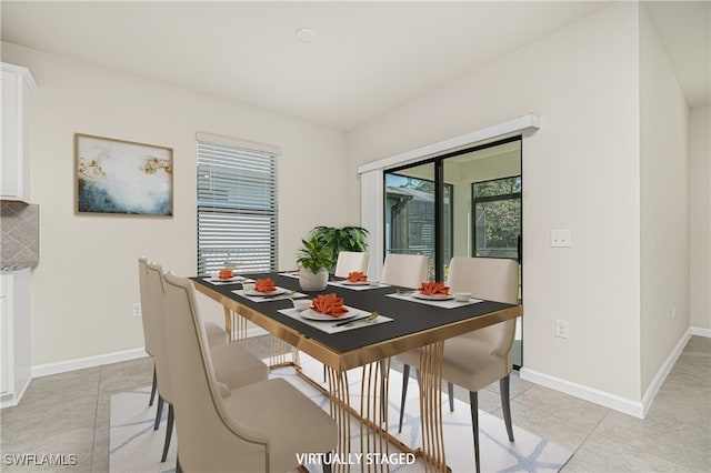 dining area featuring a healthy amount of sunlight and light tile patterned flooring