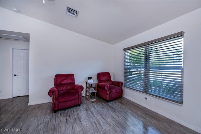 sitting room featuring lofted ceiling and hardwood / wood-style floors