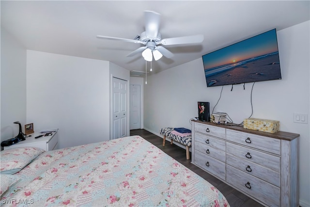 bedroom with dark hardwood / wood-style flooring, a closet, and ceiling fan