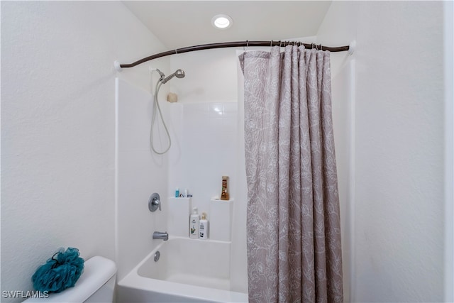 bathroom featuring toilet and shower / bathtub combination with curtain