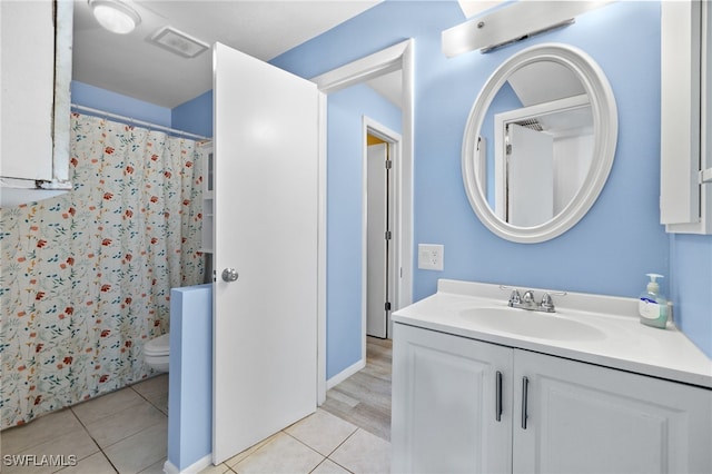 bathroom with vanity, toilet, and tile patterned flooring