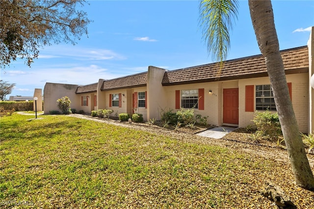 ranch-style home featuring a front yard