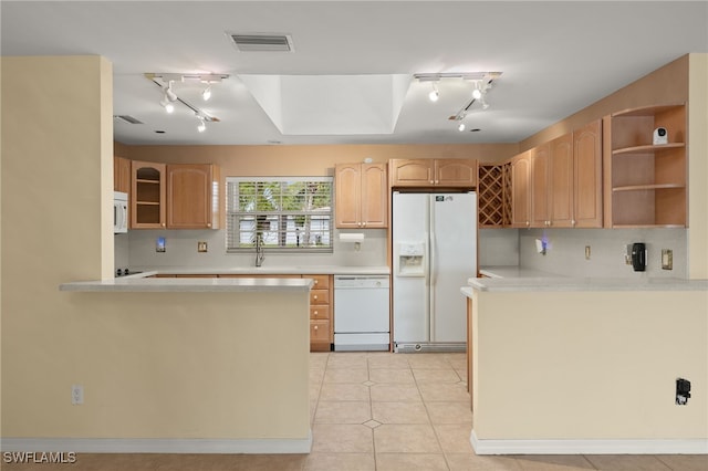 kitchen with light tile patterned flooring, sink, kitchen peninsula, white appliances, and backsplash