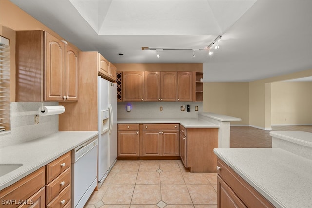 kitchen with backsplash, white appliances, and light tile patterned flooring