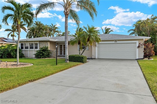 ranch-style house with a garage and a front lawn