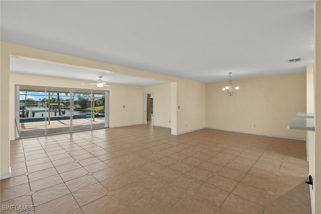 unfurnished room featuring ceiling fan with notable chandelier