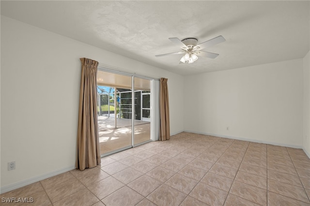 tiled empty room with ceiling fan