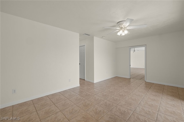 spare room featuring light tile patterned floors and ceiling fan