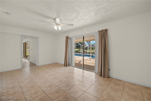 tiled spare room featuring a textured ceiling and ceiling fan