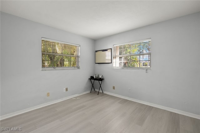 spare room featuring light hardwood / wood-style flooring