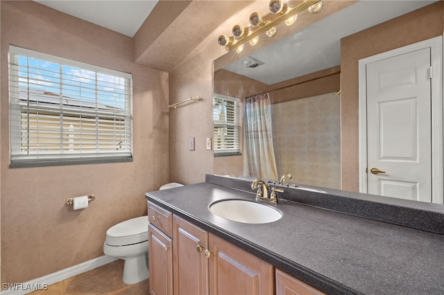 bathroom featuring a shower with curtain, vanity, tile patterned flooring, and toilet