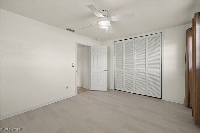 unfurnished bedroom with ceiling fan, a closet, and light hardwood / wood-style flooring