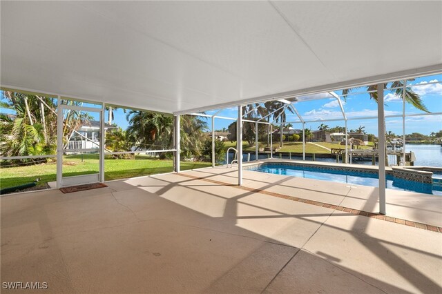 view of swimming pool featuring a lanai, a patio area, an in ground hot tub, and a water view