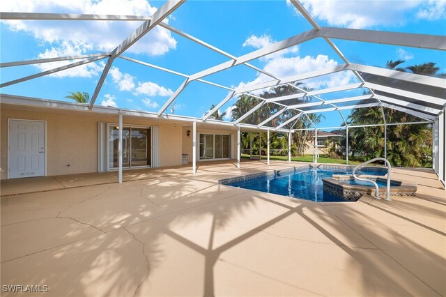 view of swimming pool with a hot tub, a patio, and a lanai