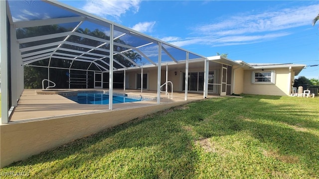 rear view of house featuring a patio, a lanai, and a lawn