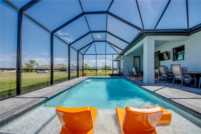 view of pool featuring a patio, a lanai, and a lawn