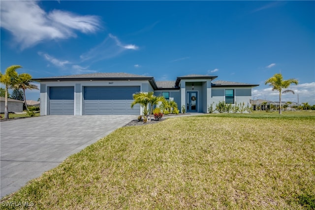 view of front of house with a garage and a front lawn