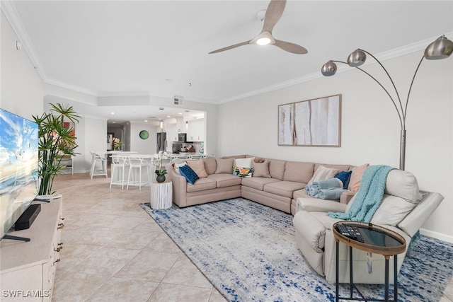 tiled living room featuring ceiling fan and ornamental molding