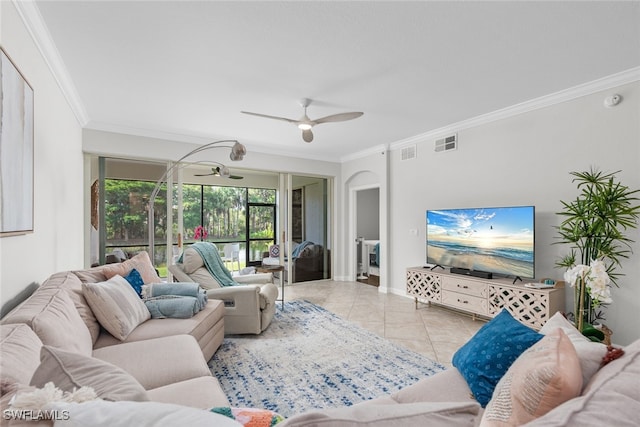 tiled living room with ceiling fan and crown molding