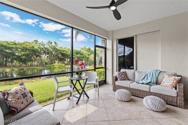 sunroom / solarium featuring a water view and ceiling fan