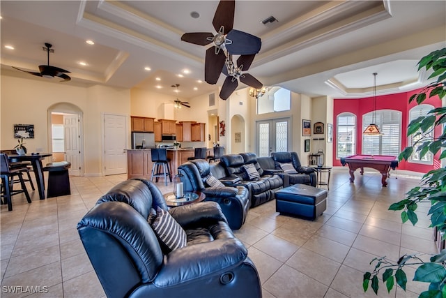 living room featuring pool table, a raised ceiling, light tile patterned floors, and a towering ceiling