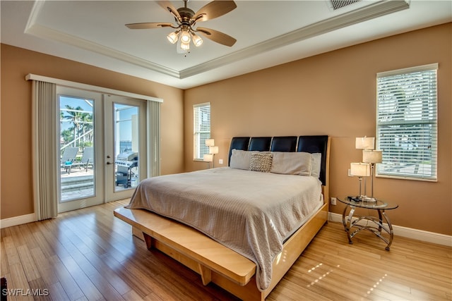 bedroom with access to outside, ceiling fan, french doors, and light wood-type flooring