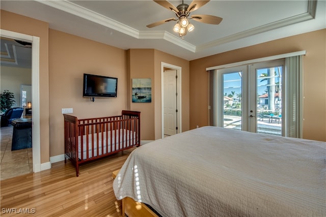 bedroom featuring access to exterior, ceiling fan, french doors, crown molding, and light hardwood / wood-style floors