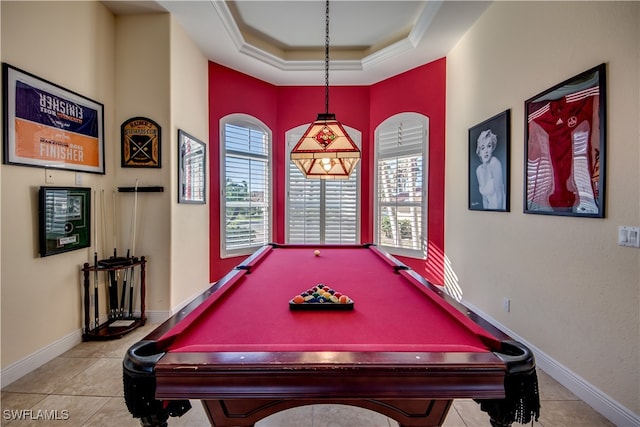 playroom featuring a tray ceiling, light tile patterned floors, and ornamental molding