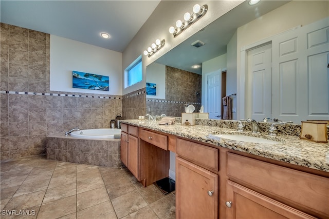 bathroom with tile patterned floors, separate shower and tub, vanity, and tile walls