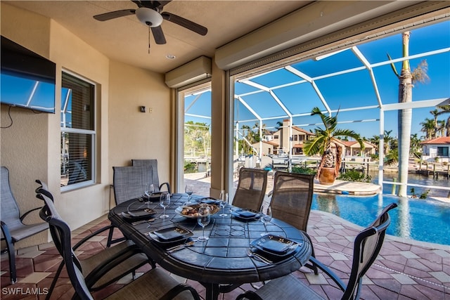 view of patio with ceiling fan and a lanai