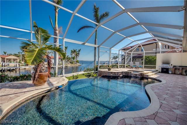 view of pool featuring an in ground hot tub, a patio, a water view, and glass enclosure