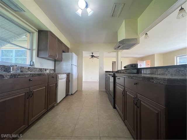 kitchen with a wealth of natural light, black electric range, light tile patterned flooring, and dishwasher