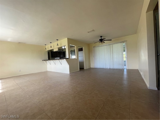 unfurnished living room with ceiling fan