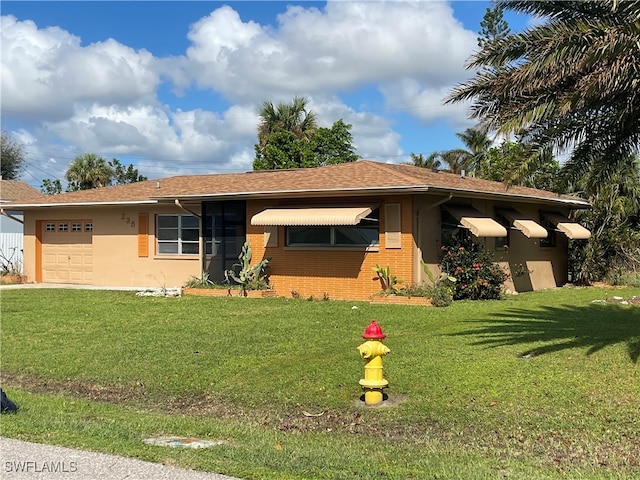 view of front facade with a front lawn and a garage