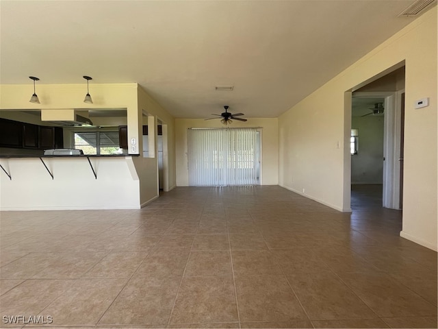 unfurnished living room with tile patterned floors and ceiling fan