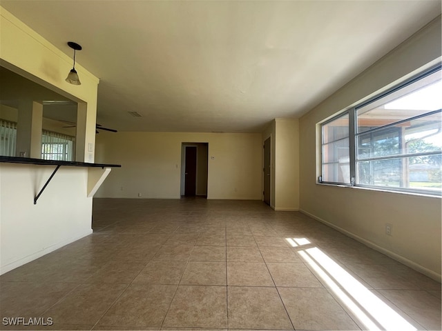 unfurnished living room with light tile patterned flooring