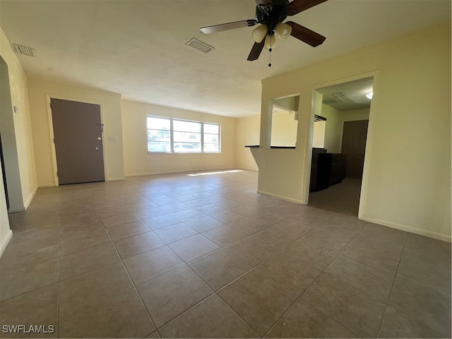 spare room with light tile patterned flooring and ceiling fan