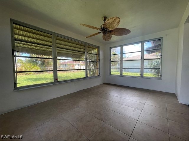 unfurnished sunroom with ceiling fan