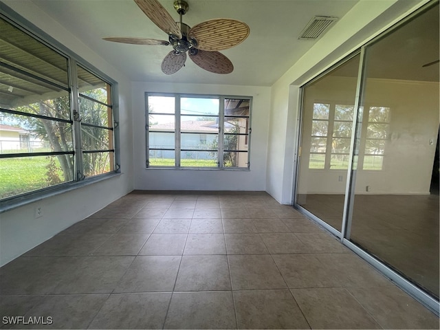 unfurnished sunroom with ceiling fan