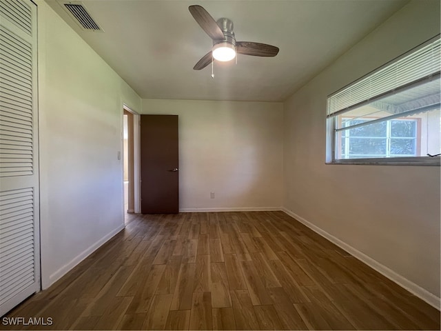 spare room featuring dark hardwood / wood-style floors and ceiling fan