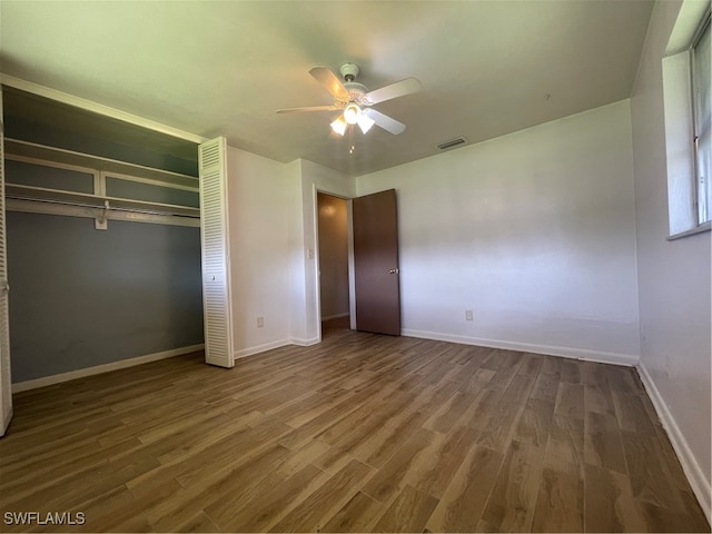 unfurnished bedroom featuring a closet, ceiling fan, and wood-type flooring