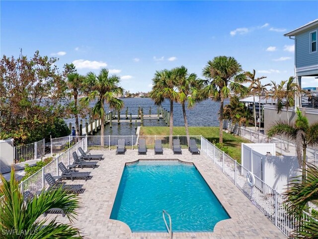 270 Delmar Ave, Fort Myers Beach, FL 33931 - view of pool featuring a water view, a patio area, a fenced backyard, and a dock