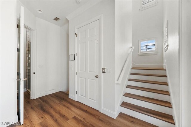 270 Delmar Ave, Fort Myers Beach, FL 33931 - stairway featuring wood finished floors and baseboards