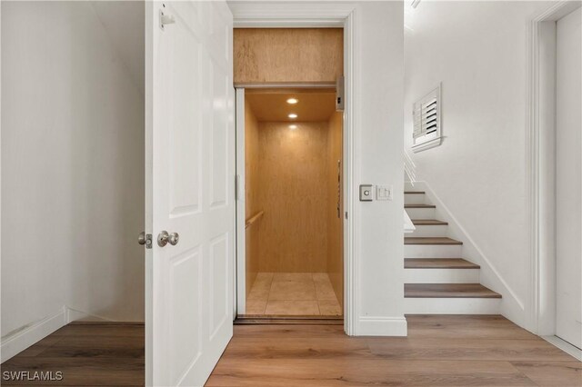 270 Delmar Ave, Fort Myers Beach, FL 33931 - stairway with elevator and wood finished floors